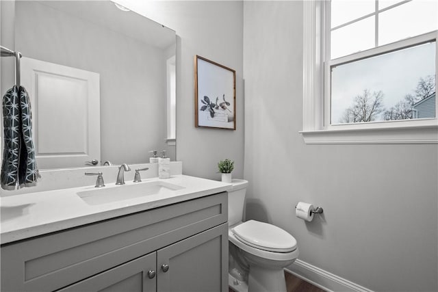 bathroom featuring vanity, hardwood / wood-style flooring, and toilet