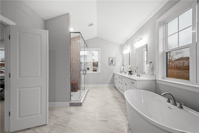 bathroom featuring a healthy amount of sunlight, vanity, vaulted ceiling, and independent shower and bath