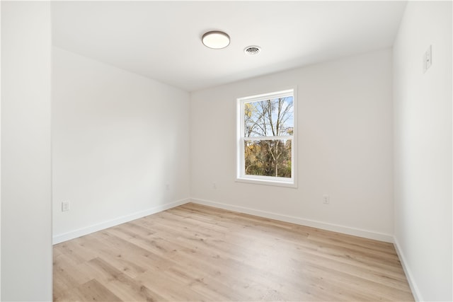 spare room featuring light wood-type flooring