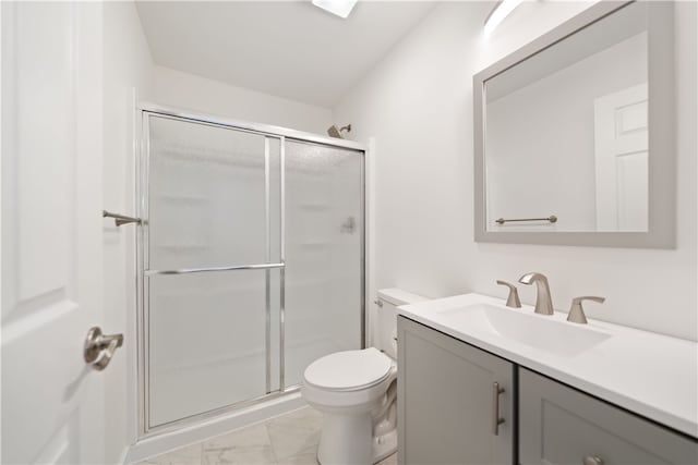 bathroom with vanity, toilet, and an enclosed shower