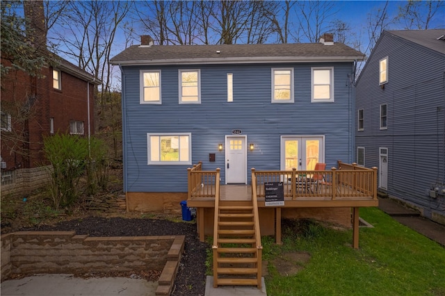 rear view of property with a wooden deck