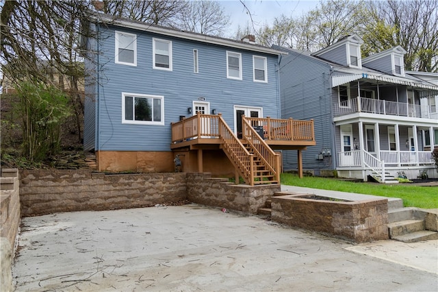 back of property with a balcony