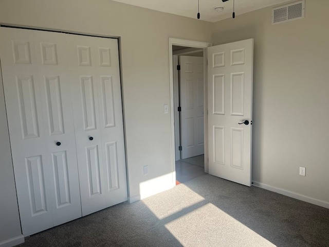 unfurnished bedroom with a closet and carpet flooring