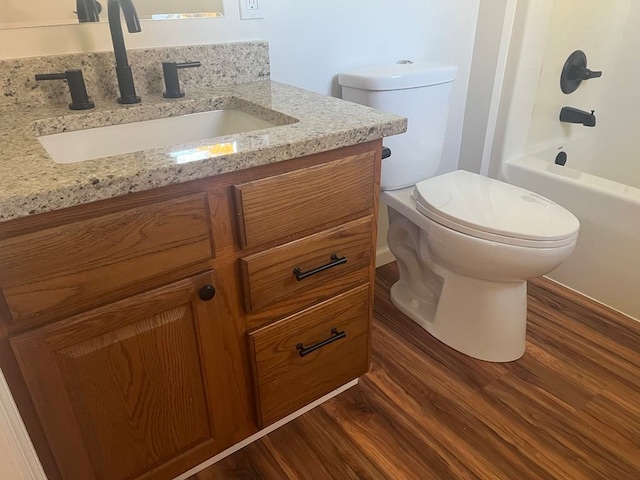 full bathroom featuring toilet, shower / bathing tub combination, vanity, and wood-type flooring