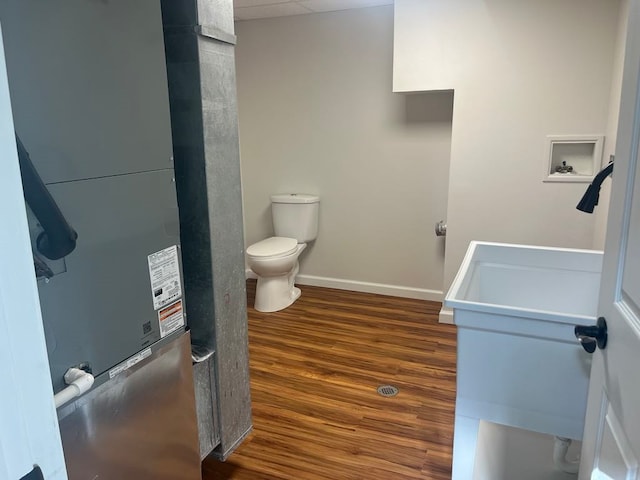 bathroom with toilet and hardwood / wood-style floors