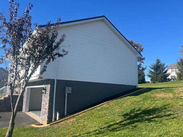 view of side of property with a yard and a garage