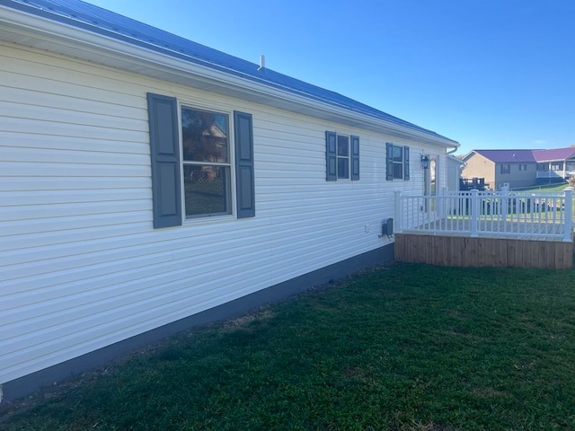 view of side of property with a yard