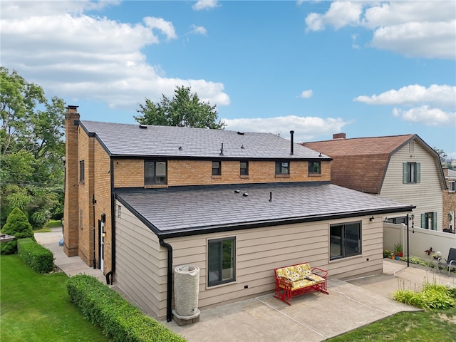 back of property featuring a patio area, a lawn, and cooling unit