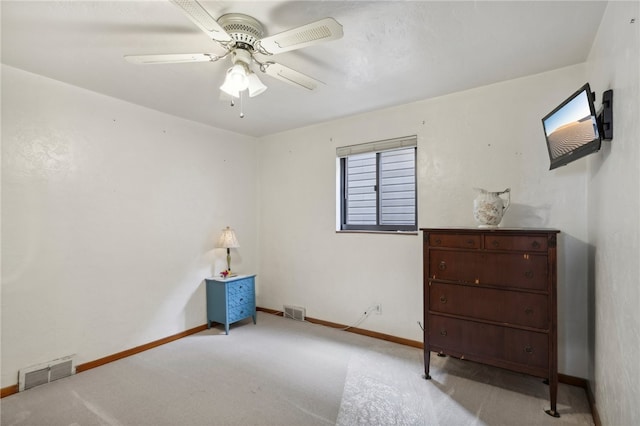 interior space with ceiling fan and light colored carpet