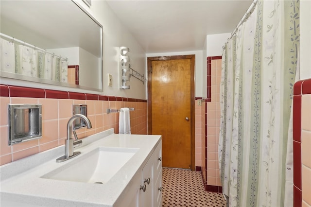 bathroom featuring tile walls, vanity, tile patterned flooring, and walk in shower