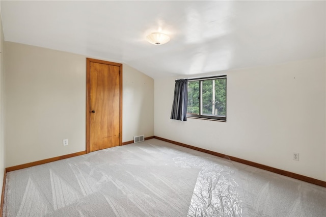 bonus room featuring light carpet and lofted ceiling