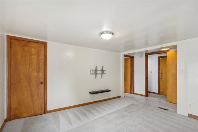 empty room featuring light colored carpet