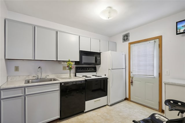 kitchen featuring white cabinetry, black appliances, and sink