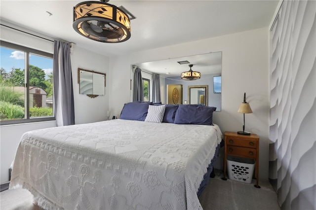 bedroom featuring multiple windows and carpet flooring