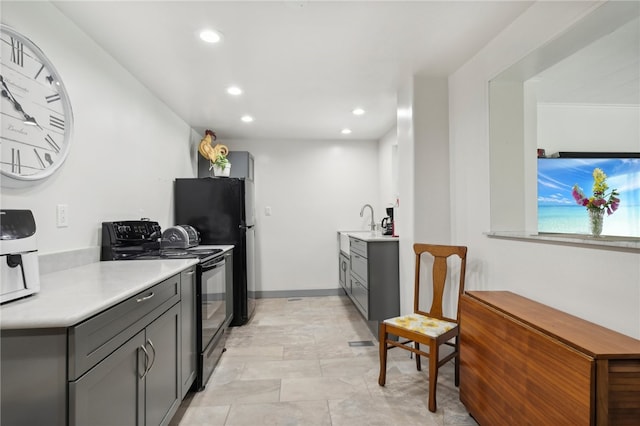 kitchen featuring black appliances, sink, and gray cabinets