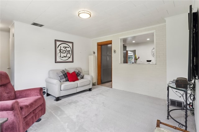 carpeted living room featuring ornamental molding