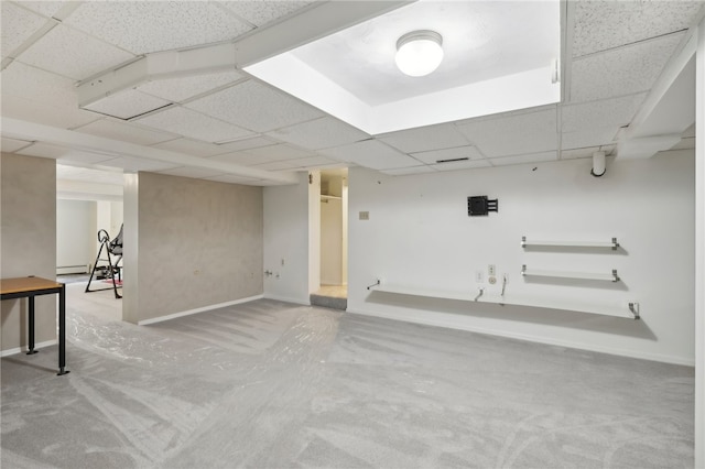 basement with a paneled ceiling