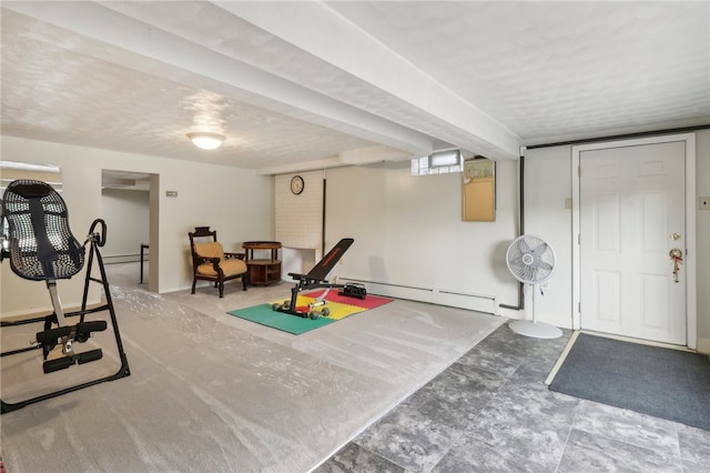 workout room with a baseboard heating unit and a textured ceiling