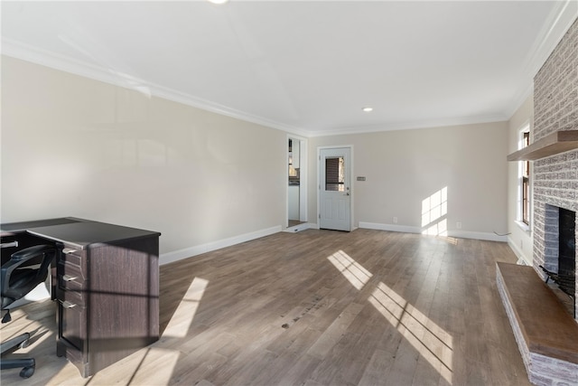 office featuring crown molding, a fireplace, and hardwood / wood-style floors