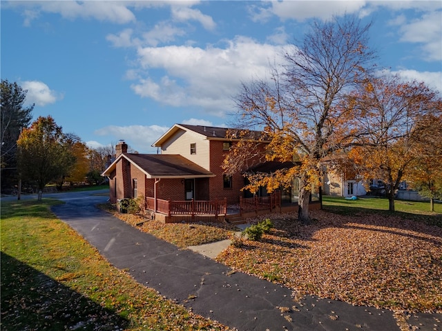 view of front of home featuring covered porch and a front yard