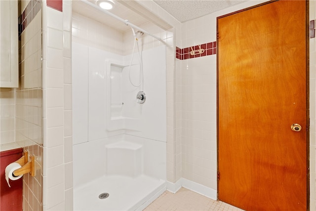 bathroom featuring a shower and a textured ceiling