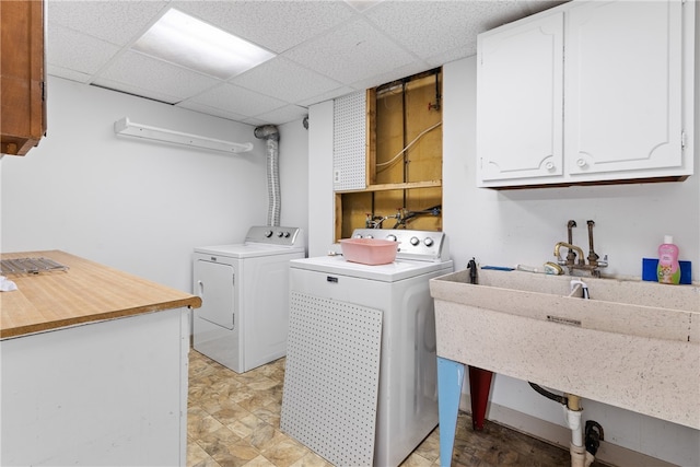 washroom featuring cabinets, sink, and separate washer and dryer