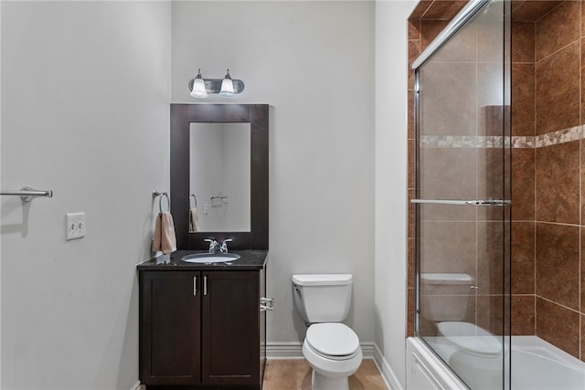 full bathroom with vanity, combined bath / shower with glass door, toilet, and tile patterned floors