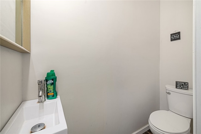 bathroom featuring toilet and sink