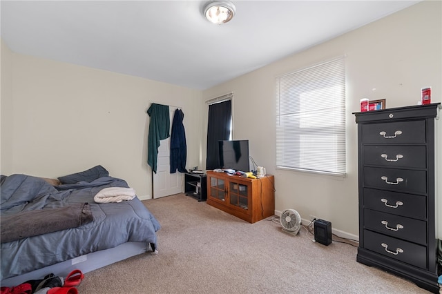 bedroom featuring light carpet