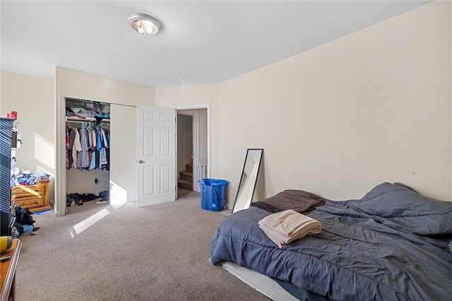 bedroom featuring light colored carpet and a closet