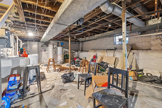 basement with water heater and washer and clothes dryer