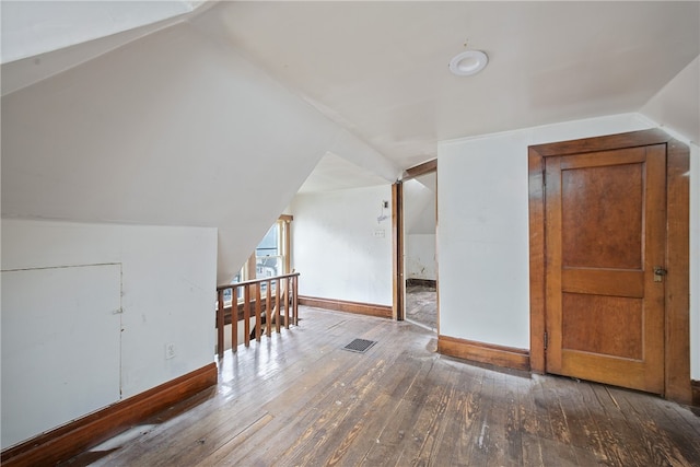 bonus room featuring lofted ceiling and dark hardwood / wood-style floors