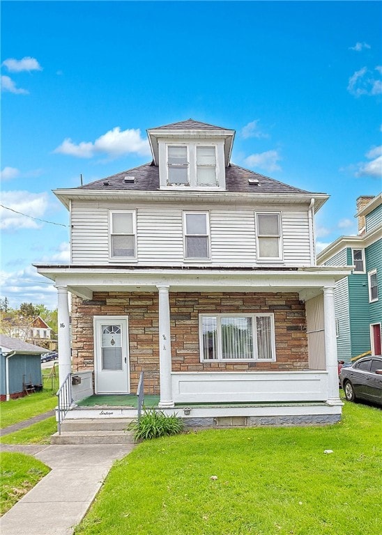 view of front of property with a porch and a front lawn