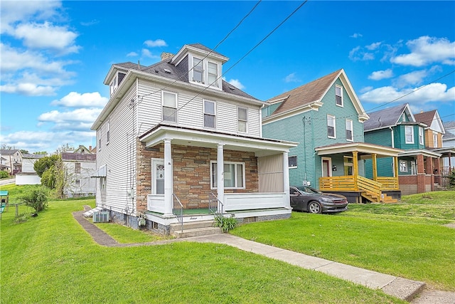 view of front facade featuring a front yard, a porch, and central AC unit