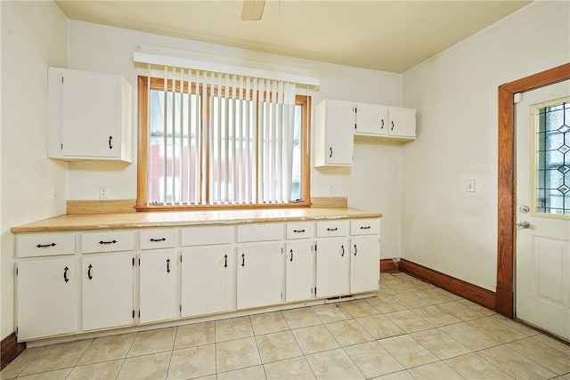 kitchen with white cabinets and light tile patterned floors