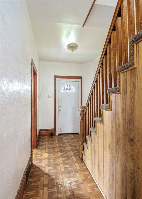 foyer entrance featuring parquet flooring