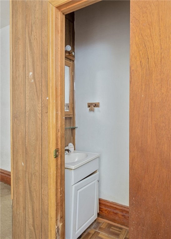 bathroom with vanity and parquet floors