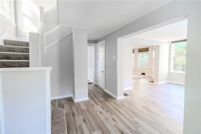 interior space with ornamental molding and hardwood / wood-style floors