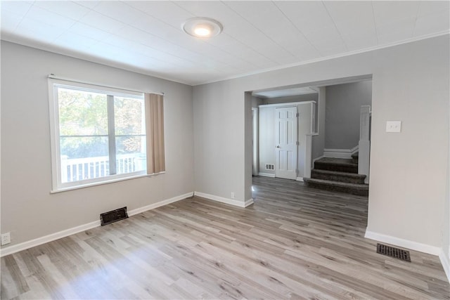 410 W Swissvale Ave, Edgewood, PA 15218 - empty room featuring visible vents, baseboards, wood finished floors, and stairway