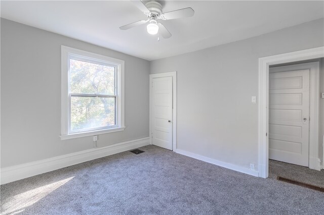 unfurnished bedroom featuring ceiling fan and carpet floors