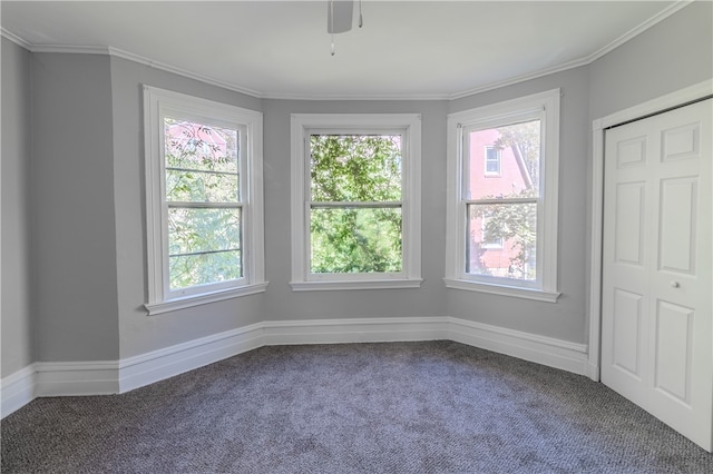 carpeted empty room with crown molding and ceiling fan