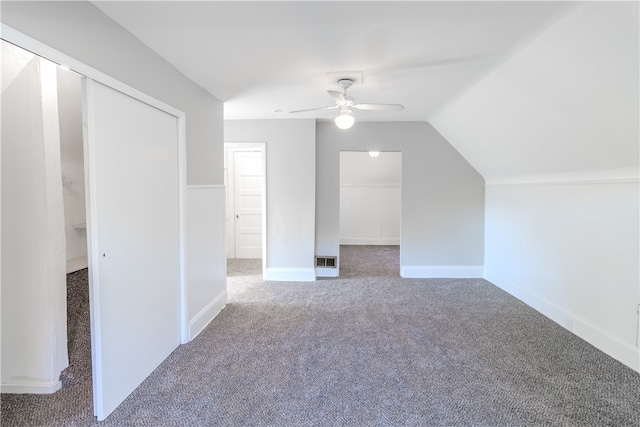 additional living space featuring vaulted ceiling, carpet floors, and ceiling fan