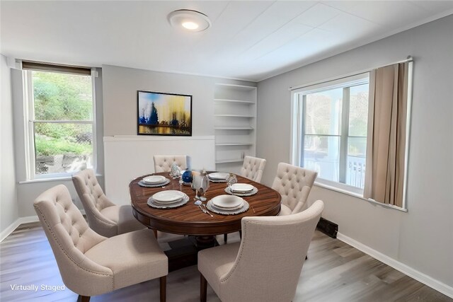 dining space with plenty of natural light and hardwood / wood-style floors