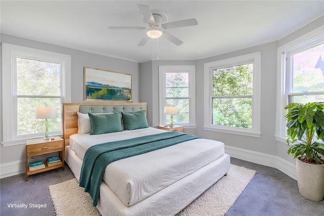 carpeted bedroom featuring crown molding and ceiling fan