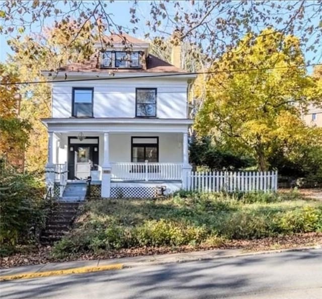 410 W Swissvale Ave, Edgewood, PA 15218 - view of front facade with covered porch, a chimney, stairway, fence, and stucco siding
