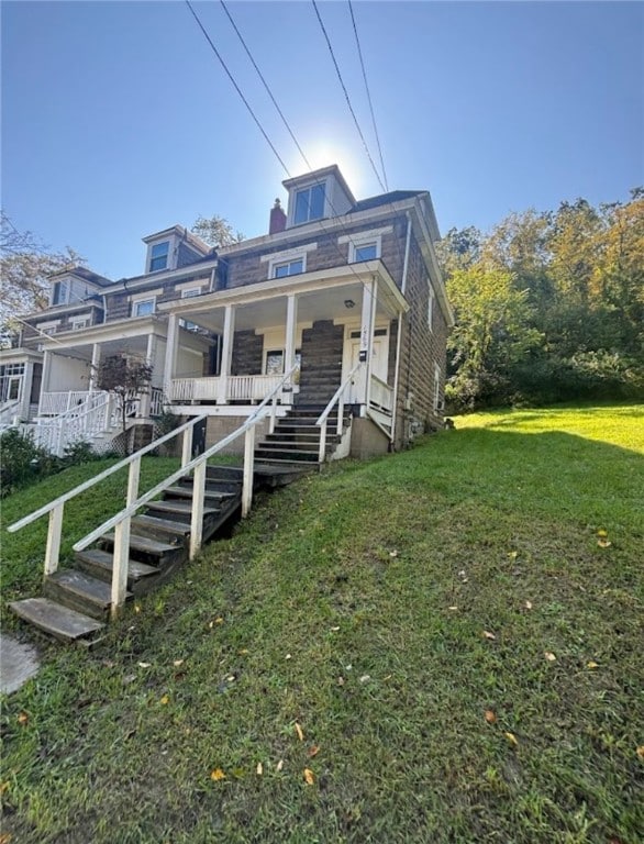 view of front of property with a front yard and a porch