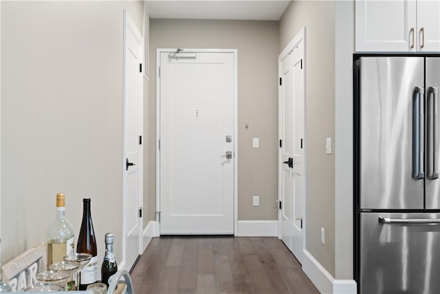 doorway to outside featuring dark wood-type flooring