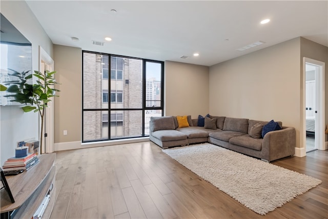 living room featuring light hardwood / wood-style floors and floor to ceiling windows