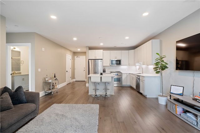 living room with sink and hardwood / wood-style floors