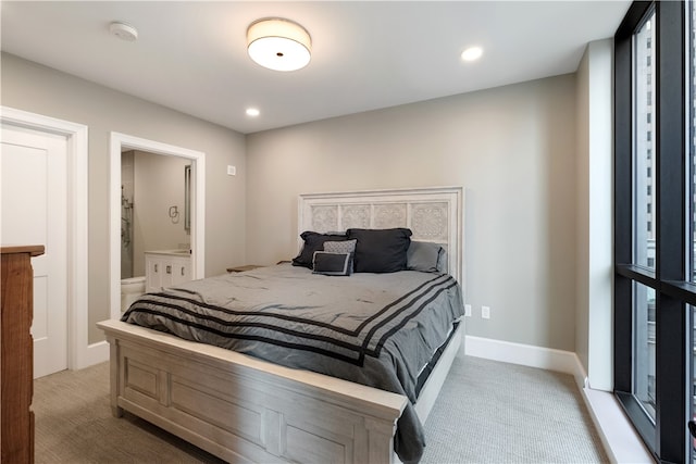 carpeted bedroom featuring ensuite bath